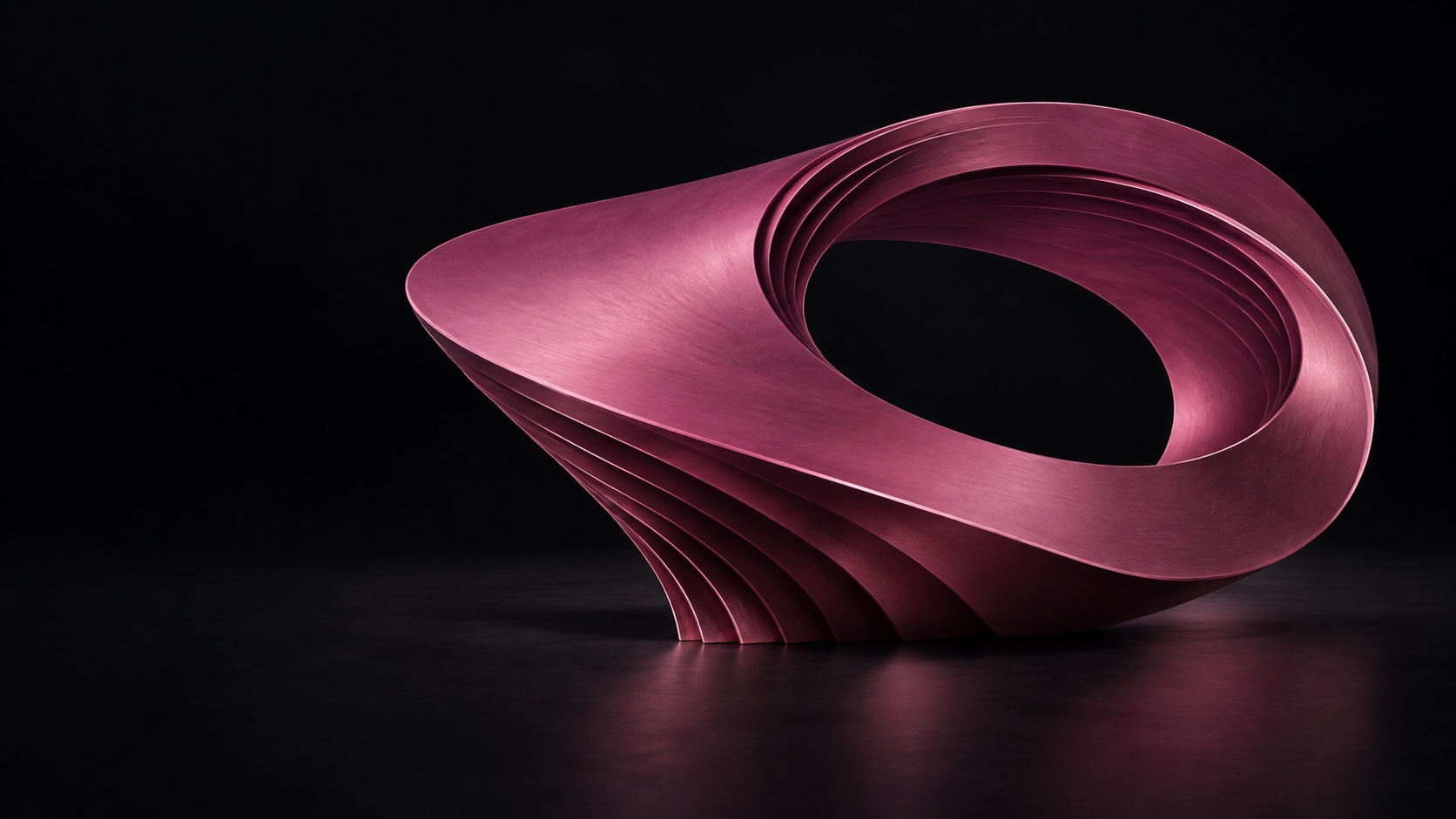An asymmetrical magenta metal shell spirals around a generous opening, with layered satin edges on a black stage.